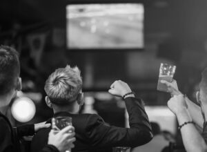 People cheering for sports with beers